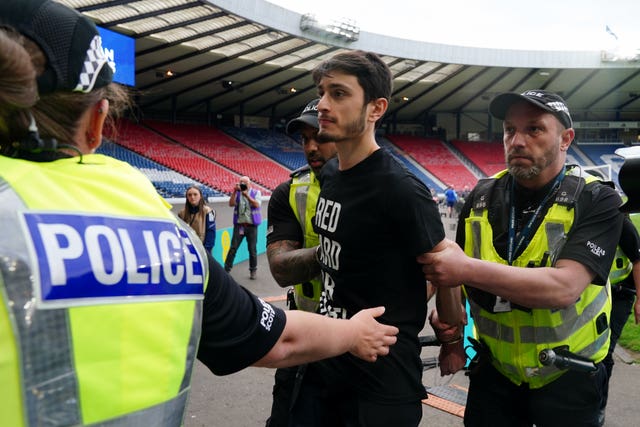 The protester is escorted away by police
