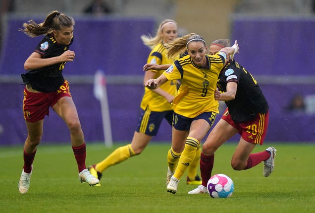 Kosovare Asllani, centre, is pulled back by Belgium's Julie Biesmans