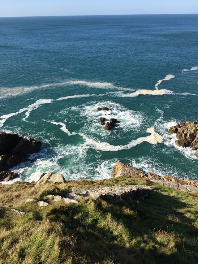 Steps cut into the cliff face leading down to the shipwreck