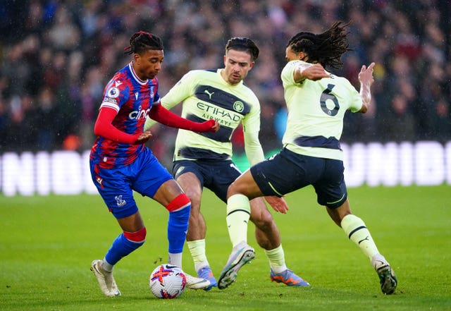 Crystal Palace’s Michael Olise, left, battles for the ball with Manchester City’s Jack Grealish and Nathan Ake