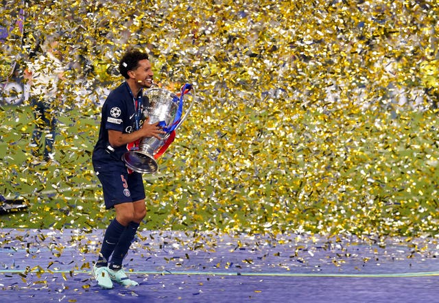 Paris Saint-Germain’s Marquinhos lifts the trophy after winning the UEFA Champions League