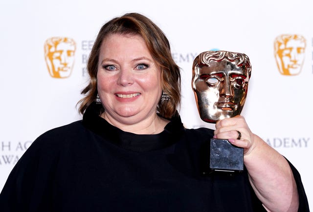 Joanna Scanlan holding a Bafta award