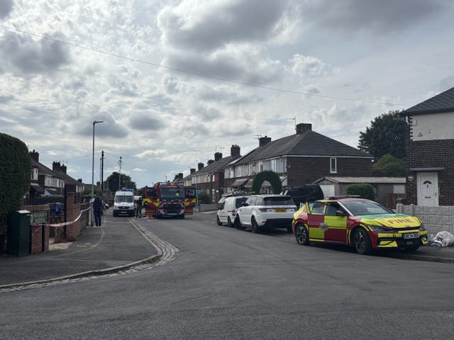 Emergency services at four houses that were damaged by a grass fire on Sandy Road, Stoke-on-Trent