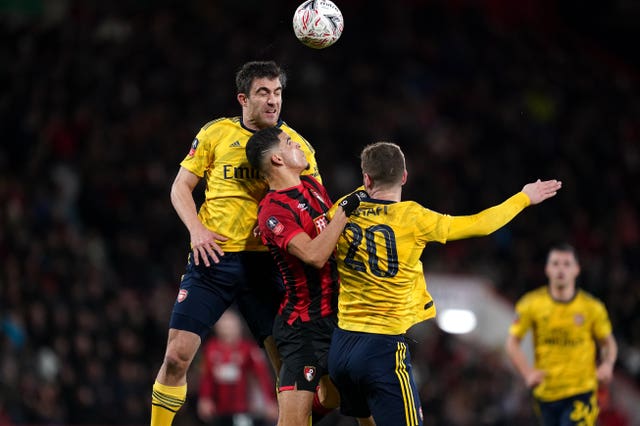 Arsenal's Sokratis (left) and Shkodran Mustafi battle for the ball with Bournemouth's Dominic Solanke during the FA Cup fourth round 