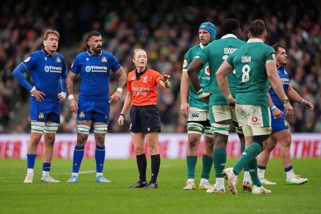 Referee Hollie Davidson, centre, delivers a decision to the Ireland players during the Six Nations match against Italy
