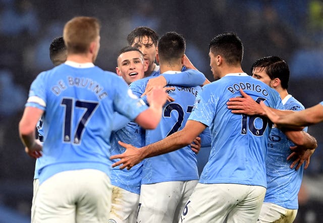 Manchester City players gather to celebrate Phil Foden's goal against Brighton on Wednesday evening