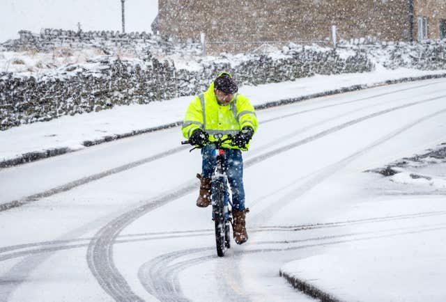 A man rides a bike in Hawes in the Yorkshire Dales National Park after the coldest night in the UK in nearly two years