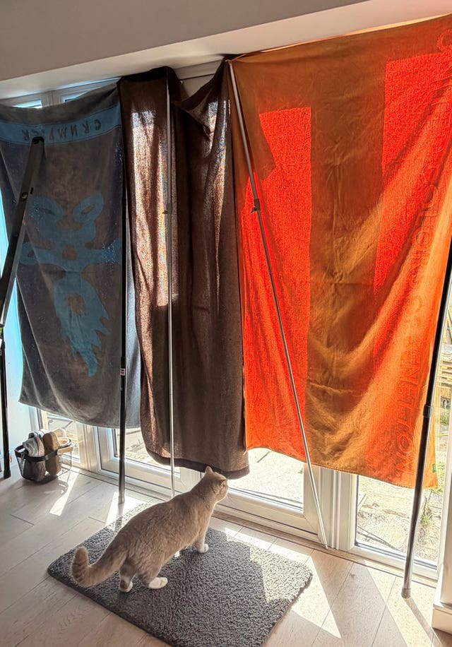 Towels and blankets are used to block the sun coming through patio doors, so pets are kept cooler, at a home