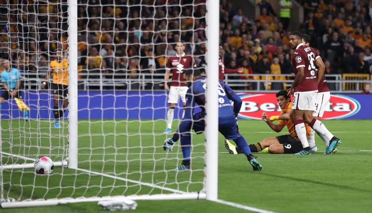 Raul Jimenez (floor right) opens the scoring for Wolves