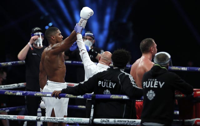 Anthony Joshua (left) celebrates after beating Kubrat Pulev to take his record to 24-1