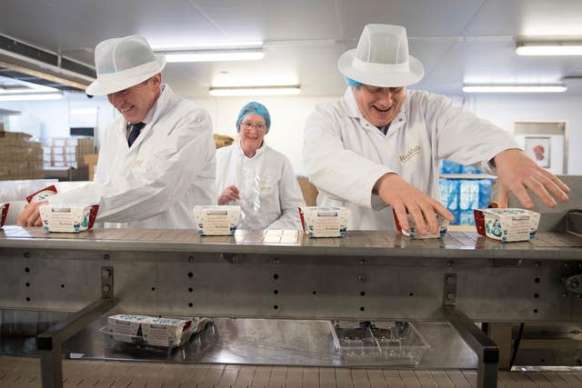 Boris Johnson and Tory candidate George Eustice helping with packaging