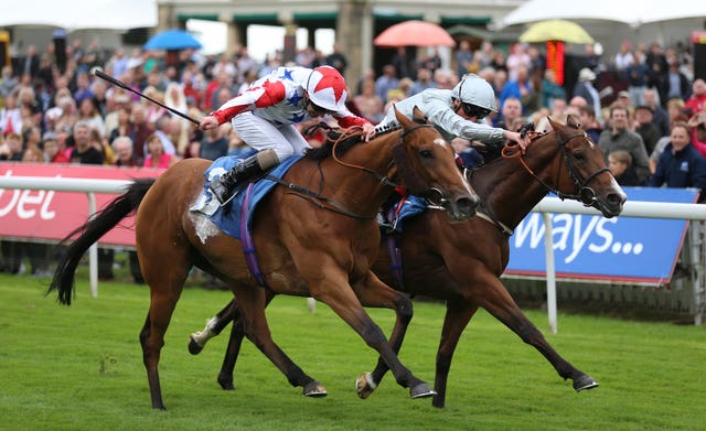 What’s The Story (left) wins the Clipper Logistics Stakes ahead of Vale Of Kent (Nigel French/PA)