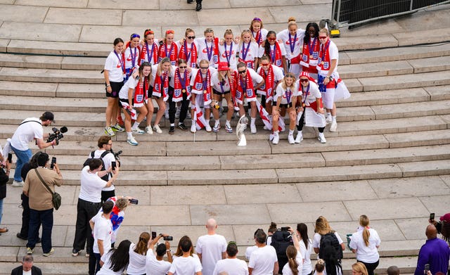 England players gather on the steps of the Victoria Memorial during a Homecoming Victory Parade