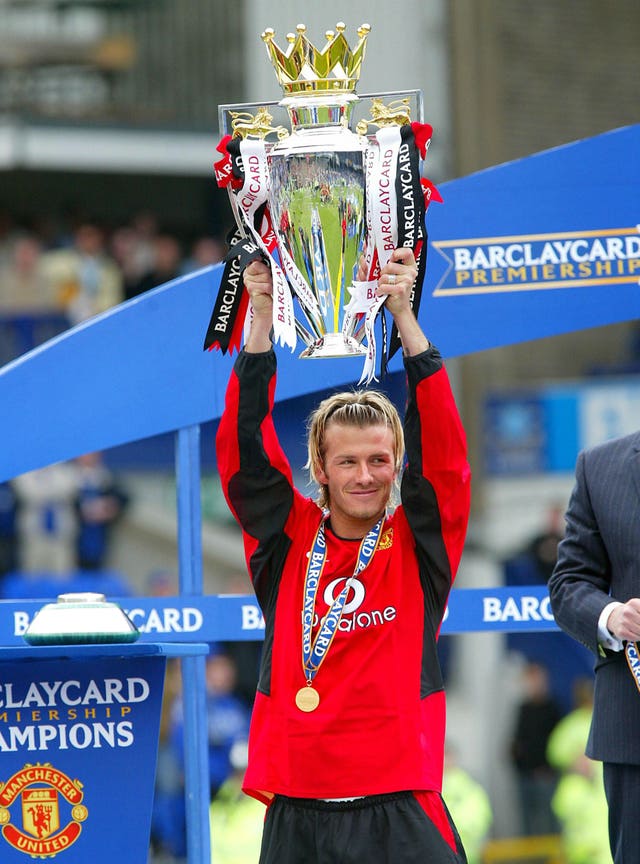 David Beckham holds aloft the Premier League trophy