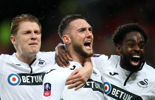 Matt Grimes, centre, celebrates his opener