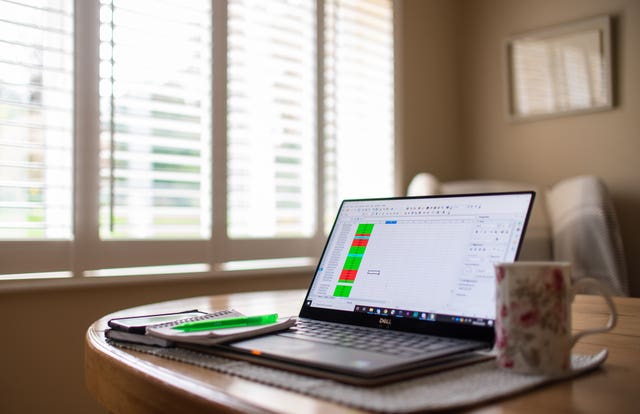 A laptop on a dining room table