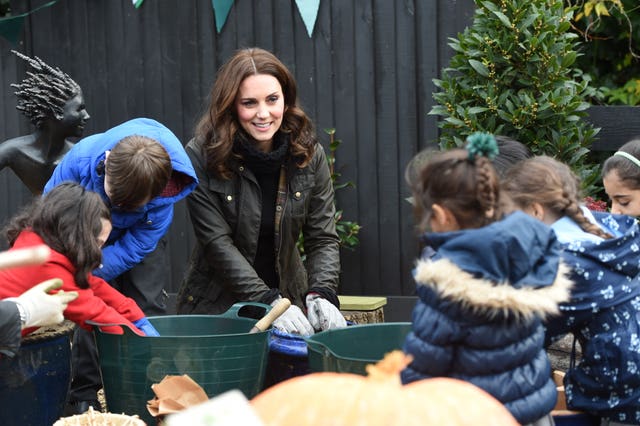 The Duchess of Cambridge planting bulbs during a visit to the Robin Hood Primary School (Eddie Mulholland/Daily Telegraph/PA)