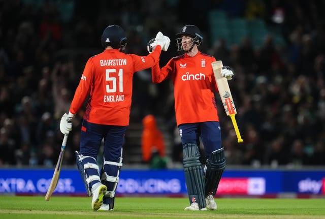 Jonny Bairstow (left) and Harry Brook (right) clasp hands while batting together for England.