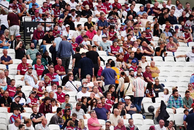 Fans leave the London Stadium early, with plenty of empty seats, as West Ham lose 3-0 to Chelsea.