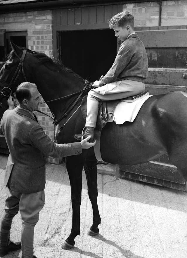 Lester Piggott, age 12, sitting on a horse at his fathers stables at Lambourn