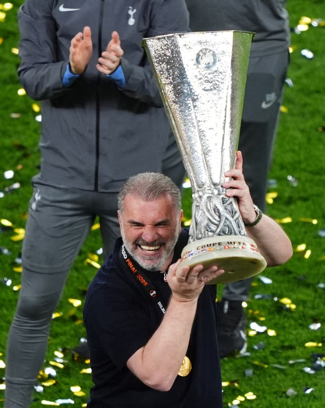 Tottenham head coach Ange Postecoglou lifts the Europa League trophy following his side's victory over Manchester United in Bilbao