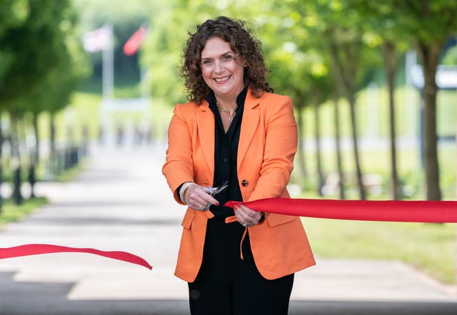 Captain Sir Tom Moore's daughter Hannah Ingram-Moore cuts a ribbon to officially open the walkway