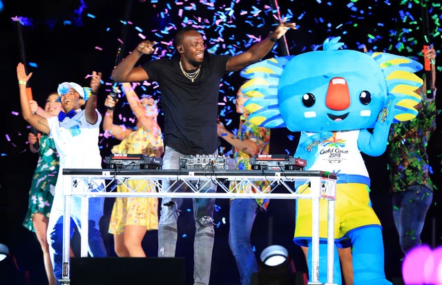 Usain Bolt and Commonwealth Games mascot Borobi the blue koala on stage (Martin Rickett/PA)