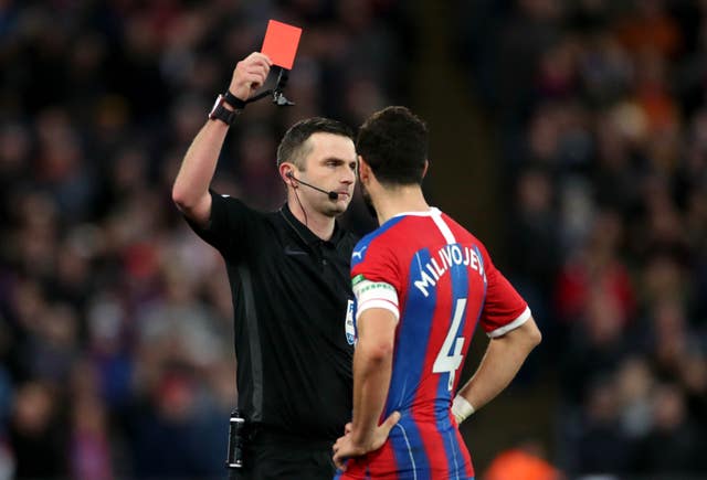 Luka Milivojevic was shown a red card by referee Michael Oliver after using the pitchside monitor