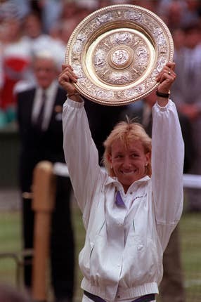 Martina Navratilova holds the singles trophy for a record ninth time