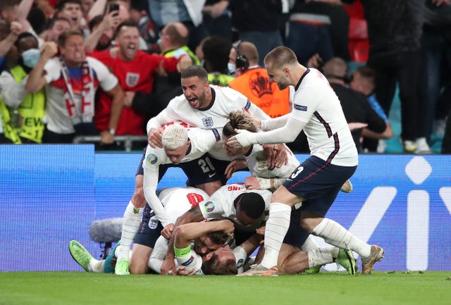 Harry Kane is mobbed by team-mates after firing England ahead from the penalty spot
