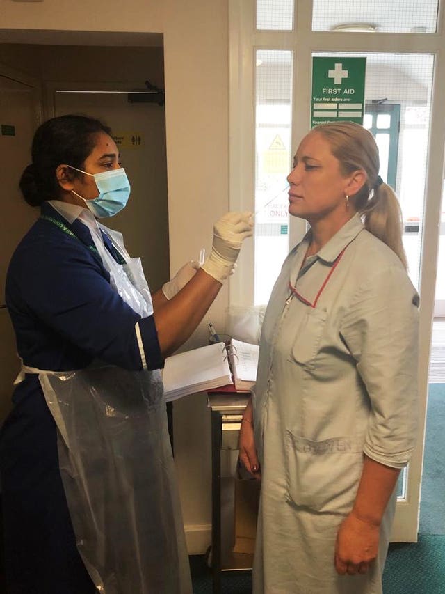 A member of staff being swabbed at a care home