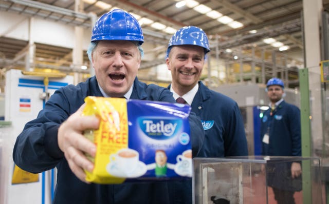 Prime Minister Boris Johnson on the production line during a visit to the Tetley Tea factory in Stockton