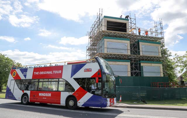 A tour bus making it’s way past broadcast studios which are being erected on the Long Walk in Windsor (PA)