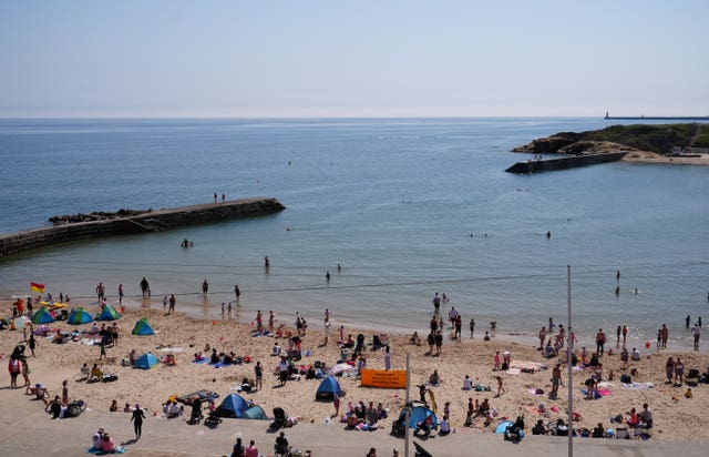 People enjoying the hot weather on the coast at Cullercoats Bay in North Tyneside
