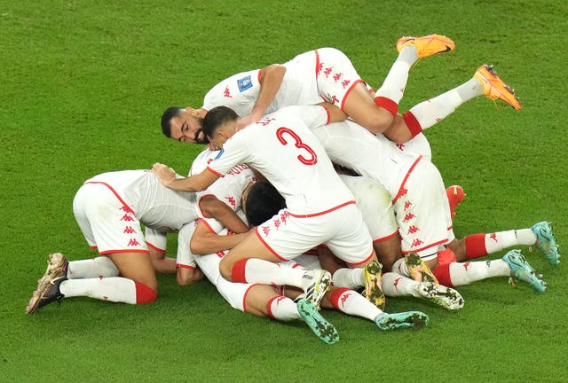Tunisia celebrate after Wahbi Khazri (hidden) gave them the lead against defending world champions France