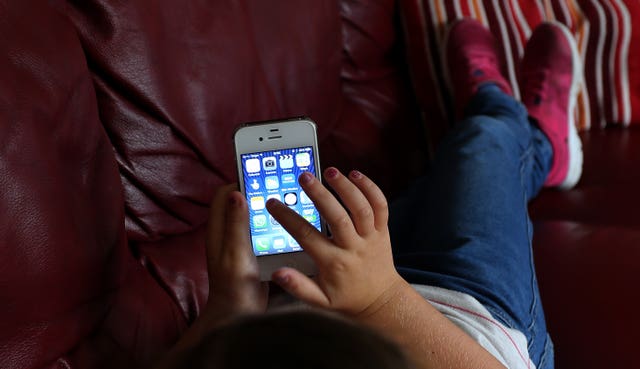 a child using an Apple iPhone