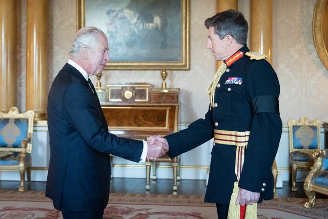 King Charles III greets Sir Gwyn during a meeting with military chiefs of staff at Buckingham Palace in 2022