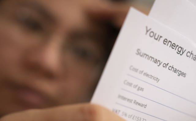 A person holding an energy bill (Danny Lawson/PA)