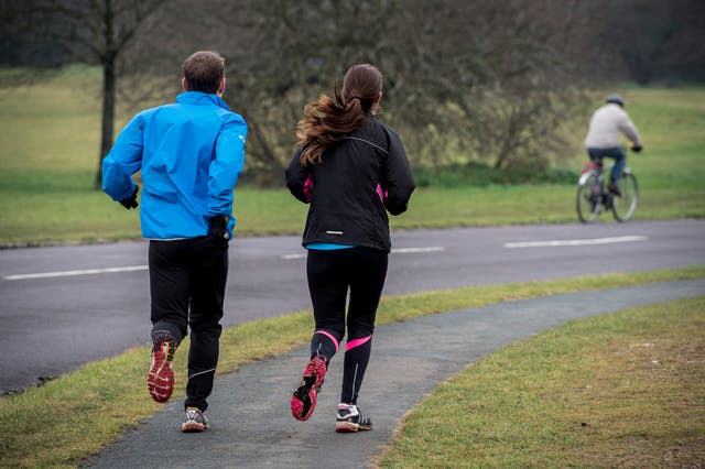 Joggers run around Clifton Downs, Bristol
