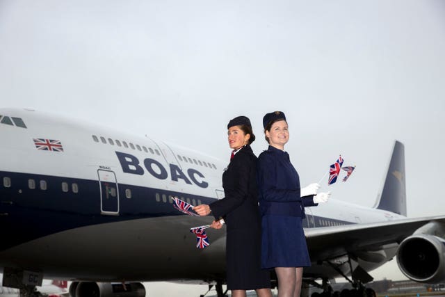 British Airways ambassadors Abigail Hunt (left) and Laura Molloy wearing an original BOAC uniform stand in front of the plane (Steve Parsons/PA)
