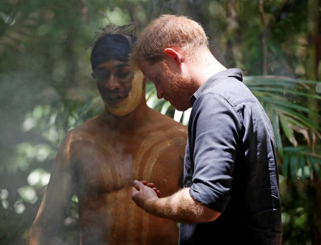 The Duke of Sussex takes part in a smoking ceremony with a member of the Butchulla (Phil Noble/PA)