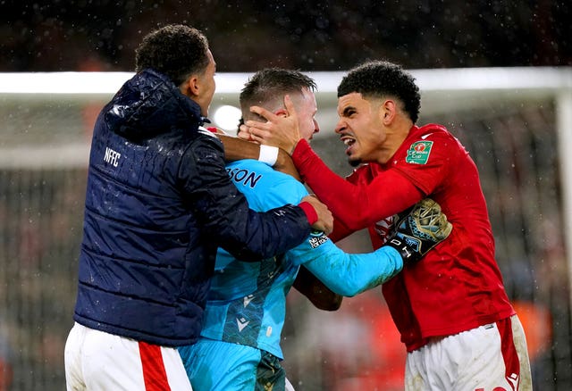 Dean Henderson celebrates with Morgan Gibbs-White and Brennan Johnson