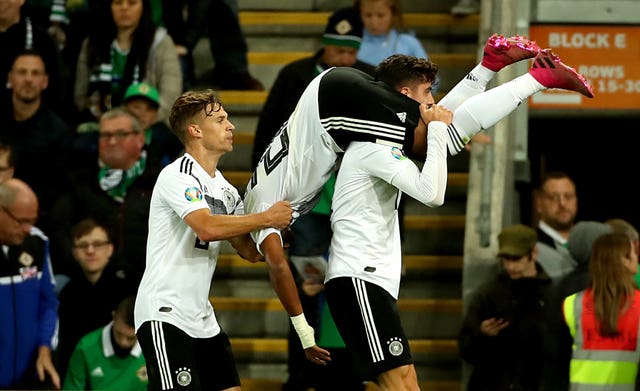 Serge Gnabry, upside down, is picked up in celebration after scoring Germany''s second
