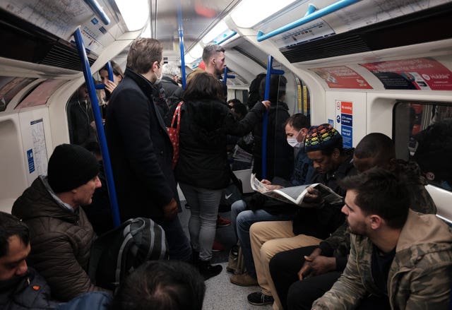 A packed carriage full of passengers travelling on the Victoria line of the London Underground
