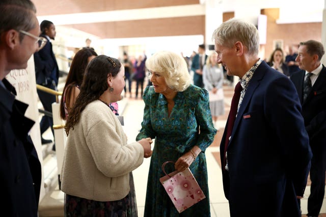 The Queen is greeted by a well wisher as she arrives to attend a Big Lunch at the British Library in London