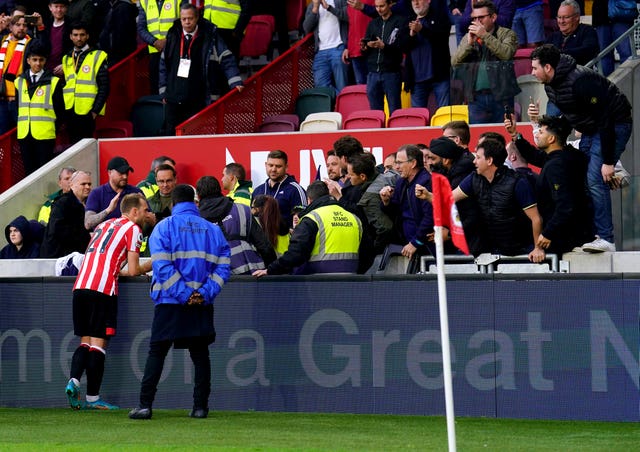 Christian Eriksen signs autographs for fans at the end of the game against Tottenham