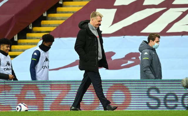 Dean Smith walks along the touchline at Villa Park