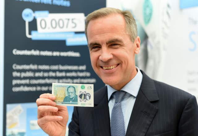 Governor of the Bank of England, Mark Carney, unveils the full design of the new polymer £5 note featuring Sir Winston Churchill (PA)
