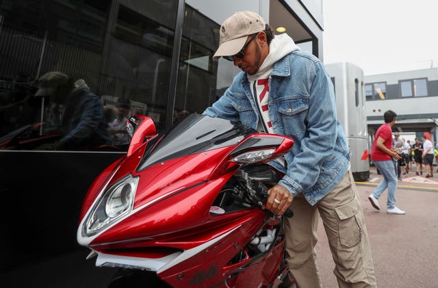 Lewis Hamilton with his motorbike in the paddock at the Monaco Grand Prix