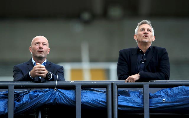 Alan Shearer, left, and Gary Lineker lean on a railing while watching a match at Newcastle